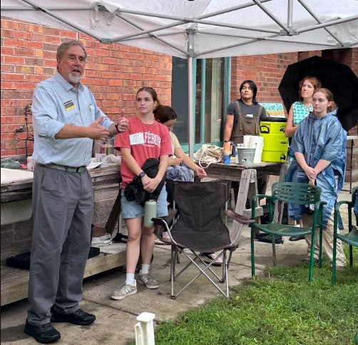 Laird Christensen in the campus garden with students